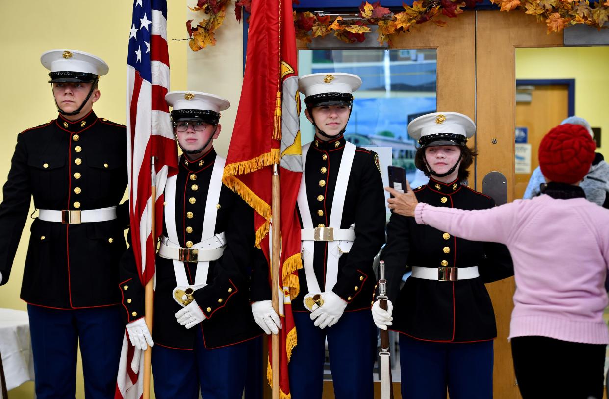 A Veterans Day program was held at the Worcester Senior Center Wednesday. Pictured, the Assabet Valley Technical High School Marine Corps JROTC. A woman showed the students a photo she had just taken of them.