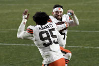 FILE - Cleveland Browns quarterback Baker Mayfield (6) celebrates with defensive end Myles Garrett (95) after defeating the Pittsburgh Steelers 48-37 during an NFL wild-card playoff football game, Sunday, Jan. 10, 2021, in Pittsburgh. The Browns chose Oklahoma quarterback and 2017 Heisman Trophy winner Mayfield one year after going with Texas A&M standout defensive end Myles Garrett. (AP Photo/Justin Berl, File)