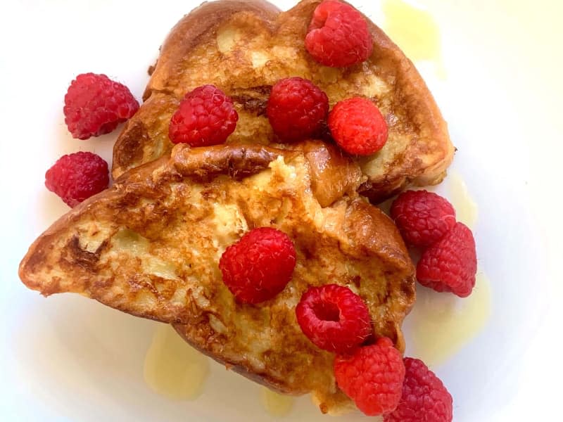 French toast topped with raspberries.