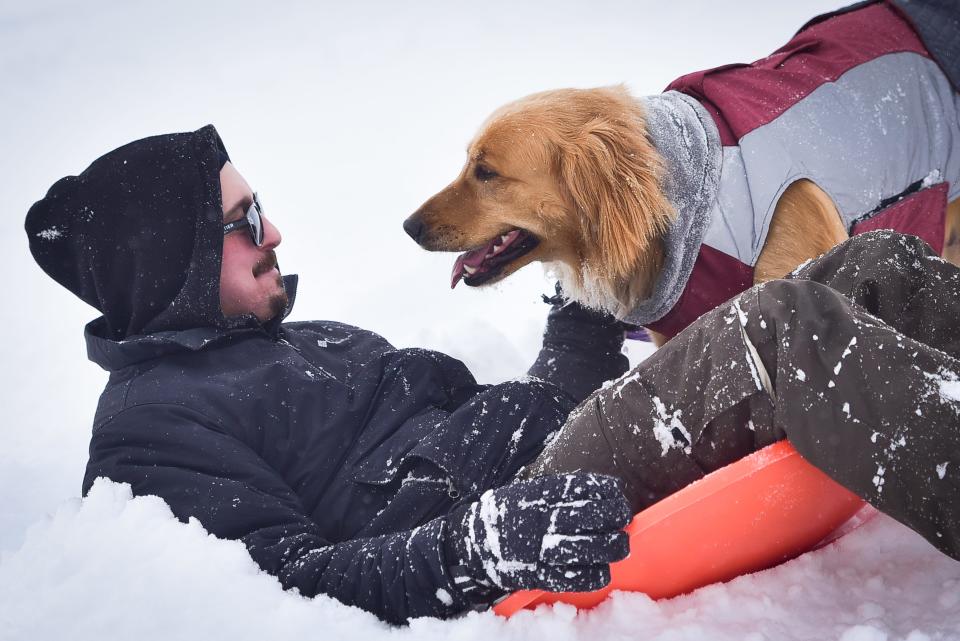 Matt Forbes goes sledding with his dog Charlotte on Tuesday, Feb. 2, 2021 at Herkimer High School.