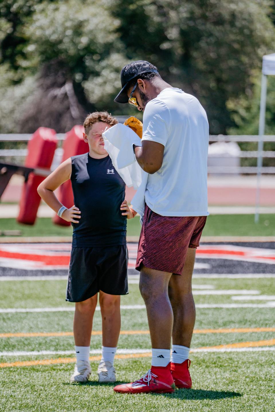 New England Patriots wide receiver Juju Smith-Schuster signs the t-shirt of 9-year-old Braxton Rodriguez during the Elite Skills Academy Camp at Foothill High School presented by P.R.O. Athletics on Saturday, July 1, 2023.