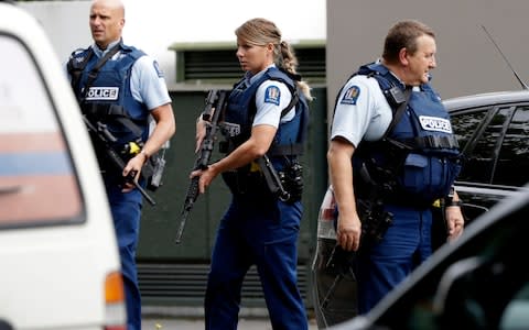 Armed police patrol outside a mosque in central Christchurch - Credit: MARK BAKER/AP