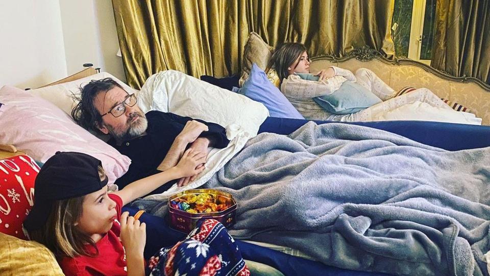 Derek Draper watching TV covered in blankets with his children