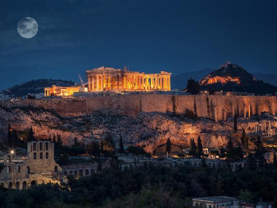 The Parthenon lit up at night is a spectacular sight (Getty)