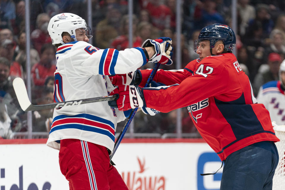 New York Rangers left wing Will Cuylle (50) and Washington Capitals defenseman Martin Fehervary (42) scuffle during the second period of an NHL hockey game, Saturday, Dec. 9, 2023, in Washington. (AP Photo/Stephanie Scarbrough)