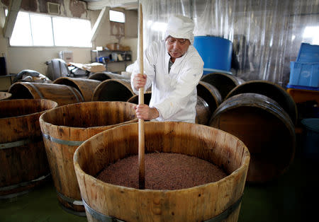 Takashi Odajima makes 'Shio-kara', a traditional fermented squid dish, at his family factory in Hakodate, Japan, July 19, 2018. REUTERS/Issei Kato/Files