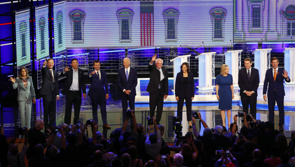 Democratic presidential candidates from left, author Marianne Williamson, former Colorado Gov. John Hickenlooper, entrepreneur Andrew Yang, South Bend Mayor Pete Buttigieg, former Vice-President Joe Biden, Sen. Bernie Sanders, I-Vt., Sen. Kamala Harris, D-Calif., Sen. Kristen Gillibrand, D-N.Y., former Colorado Sen. Michael Bennet and Rep. Eric Swalwell, D-Calif., wave as they enter the stage for the second night of the Democratic primary debate hosted by NBC News at the Adrienne Arsht Center for the Performing Arts, Thursday, June 27, 2019, in Miami. (AP Photo/Wilfredo Lee)