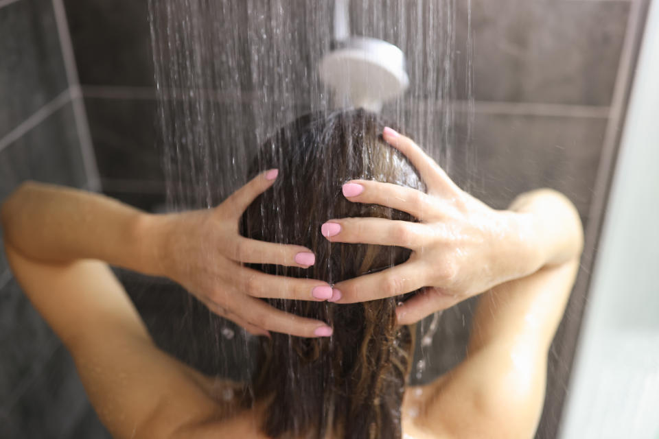 Woman takes shower in the bathroom. Feminine hygiene rules concept