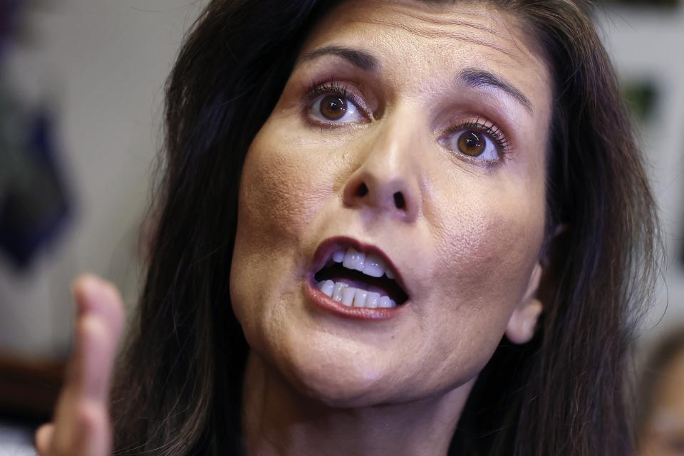 FILE - Former U.N. Ambassador Nikki Haley speaks with reporters after signing papers to get on the Republican presidential primary ballot at the New Hampshire Statehouse, Friday, Oct. 13, 2023, in Concord, N.H. The Republican Party’s White House hopefuls are offering conflicting messages on the growing foreign policy challenges. A presidential election that has long been centered on domestic kitchen-table issues is suddenly shifting its focus abroad with the Israel-Hamas war. (AP Photo/Michael Dwyer, File)