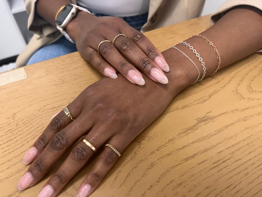 Static Flower owner and microwelder Hailey Smith wearing her permanent jewelry.