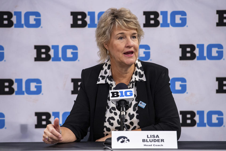 FILE - Iowa women's head coach Lisa Bluder addresses the media during the first day of the Big Ten NCAA college basketball media days, Thursday, Oct. 7, 2021, in Indianapolis. A COVID-19 outbreak that put the Iowa women's basketball season on pause cost the Hawkeyes a chance to play two games in Cancun. Bluder said she didn’t know how many players and staff are vaccinated and didn’t disclose how many people in the program tested positive for COVID-19 or had to sit out because of contact tracing. (AP Photo/Doug McSchooler, File)