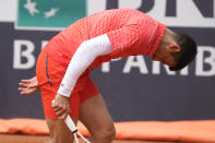 Serbia's Novak Djokovic leans on the court during the quarter final match against Denmark's Holger Rune at the Italian Open tennis tournament, in Rome, Wednesday, May 17, 2023. (AP Photo/Gregorio Borgia)