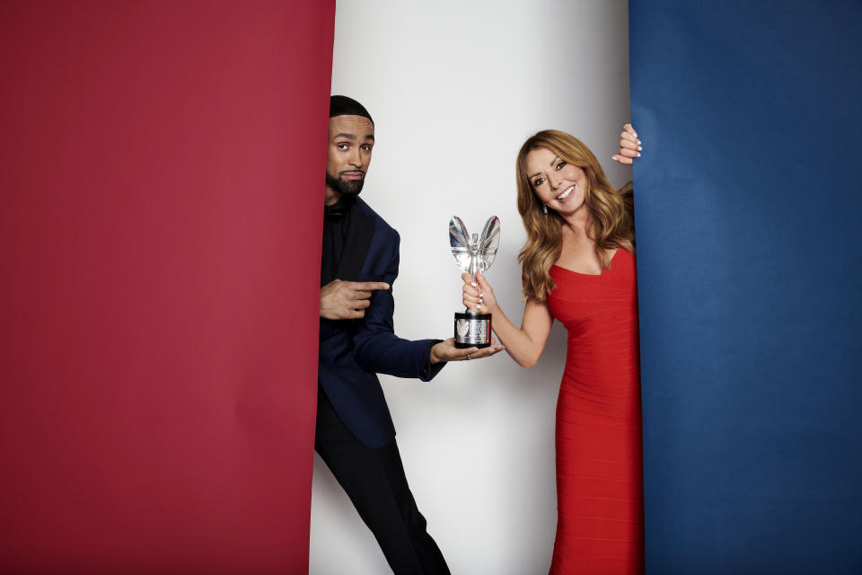 Carol Vorderman and Ashley Banjo hold Pride of Britain trophy 