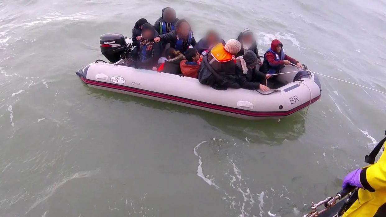 Editors please note – footage blurred at source Screengrab taken from handout bodyworn footage taken in November 2019 issued by the Royal National Lifeboat Institution (RNLI) showing a dinghy full of migrants being rescued by the RNLI in the English Channel. The clip shows around 12 people in a small inflatable being pulled to safety by lifeboat volunteers, and include a baby and at least one other child. Issue date: Wednesday July 28, 2021. (PA Media)