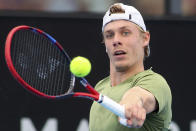 Canada's Denis Shapovalov makes a backhand return to Russia's Roman Safiullin during their Round of 16 match at the Adelaide International Tennis tournament in Adelaide, Australia, Thursday, Jan. 5, 2023. (AP Photo/Kelly Barnes)