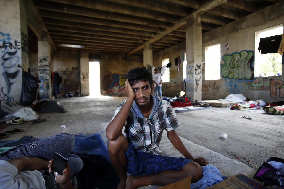 In this photo taken on Tuesday, Aug. 14, 2018, a migrant man rests on the floor of a makeshift migrant camp in Bihac, 450 kms northwest of Sarajevo, Bosnia. Impoverished Bosnia must race against time to secure proper shelters for at least 4,000 migrants and refugees expected to be stranded in its territory during coming winter. The migrant trail shifted toward Bosnia as other migration routes to Western Europe from the Balkans were closed off over the past year. (AP Photo/Amel Emric)