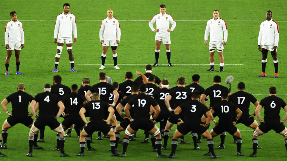 England's players are pictured forming a 'V' around the All-Blacks' haka. 