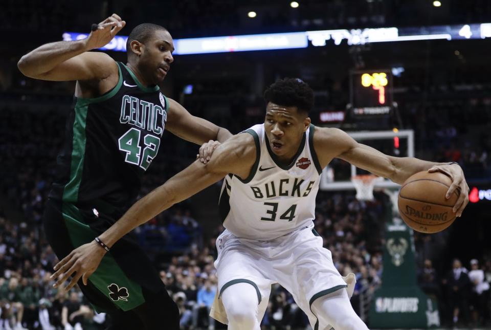 Milwaukee Bucks’ Giannis Antetokounmpo tries to drive past Boston Celtics’ Al Horford during the first half of Game 4 in Milwaukee. (AP Photo/Morry Gash)