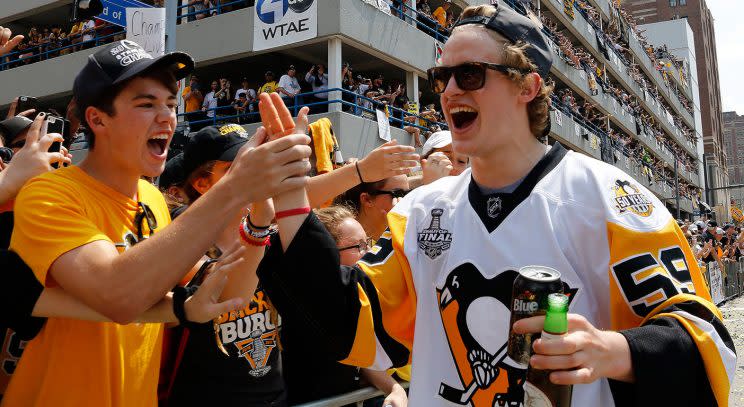 Penguins’ Jake Guentzel celebrates with a fan. (Gene J. Puskar/AP)