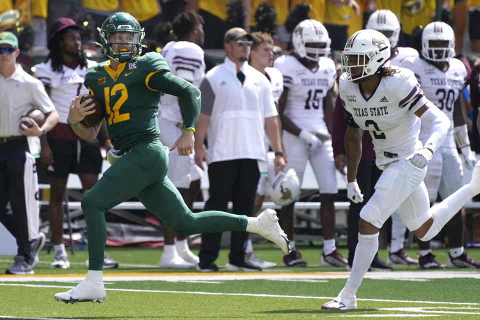 Baylor quarterback Blake Shapen (12) rushes for a touchdown against Texas State cornerback Kordell Rodgers during the first half of an NCAA college football game in Waco, Texas, Saturday, Sept. 17, 2022. (AP Photo/LM Otero)