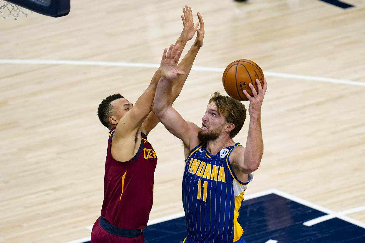 Indiana Pacers forward Domantas Sabonis (11) shoots over Cleveland Cavaliers guard Dante Exum (1) during the first half of an NBA basketball game in Indianapolis, Thursday, Dec. 31, 2020. (AP Photo/Michael Conroy)