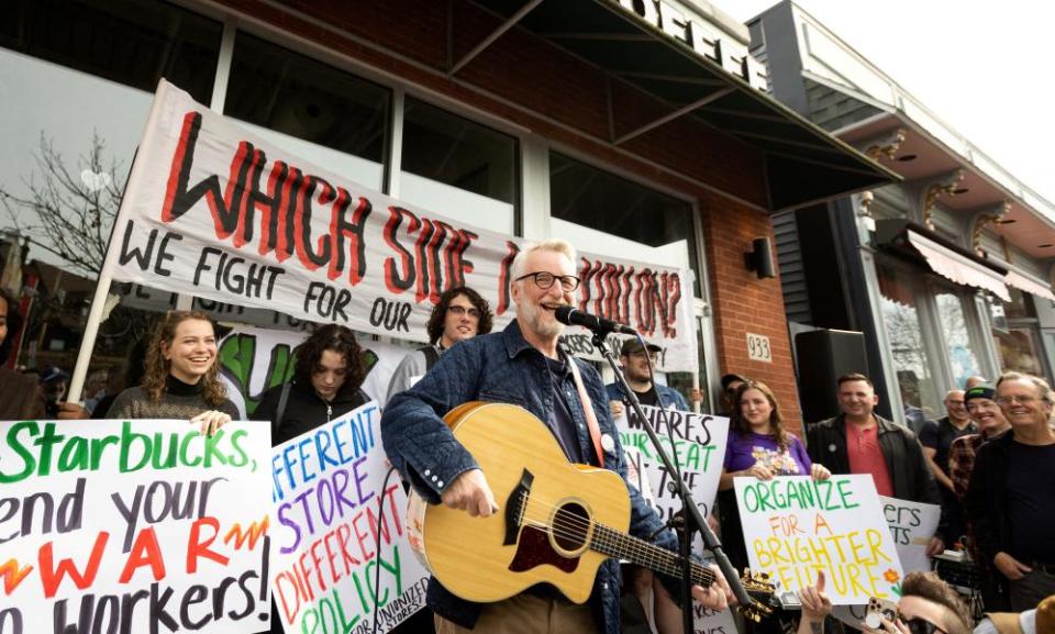 The singer Billy Bragg performs for striking Starbucks Workers United union members outside a Starbucks location in Buffalo, New York, on 12 October 2022.