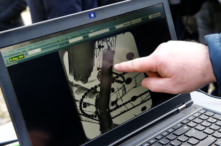 A staff show the detection of an engine in the frame of a bike during the demonstration of the use of the x-ray machine after an International Cycling Union (UCI) news conference on the fight against technological fraud in Geneva, Switzerland March 21, 2018. REUTERS/Denis Balibouse