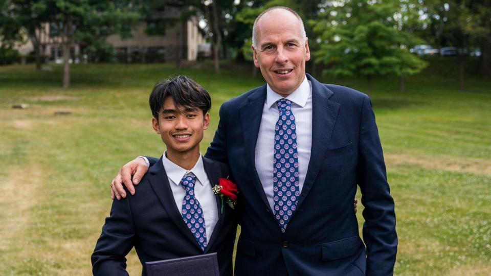 PHOTO: Thai cave survivor Adul Samon hold his high school diploma from The Masters School, standing next to rescuer Rick Stanton. (Isaac Cass/The Masters School)