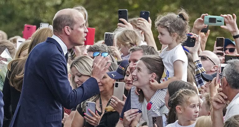 Prince William meets people after viewing the floral tributes for the late Queen Elizabeth II outside Windsor Castle, in Windsor, England, Saturday, Sept. 10, 2022. (AP Photo/Martin Meissner)