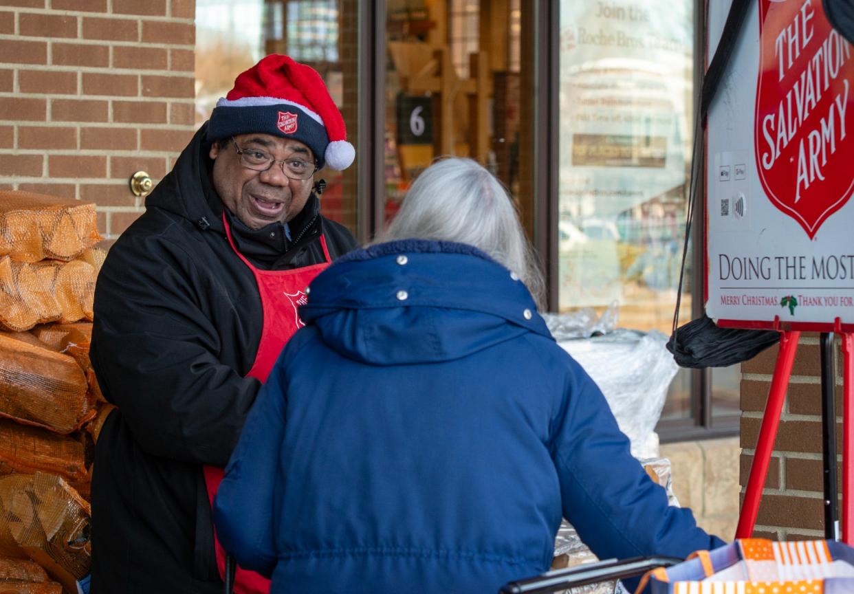 Salvation Army bell ringer Keith Bryant Sr. thanks a woman putting money in his kettle outside Roche Bros. Supermarket Friday in Westborough.