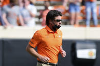 Oklahoma State head coach Mike Gundy jogs onto the field at the start of an NCAA college football game against Tulsa, Saturday, Sept. 19, 2020, in Stillwater, Okla. (AP Photo/Brody Schmidt)