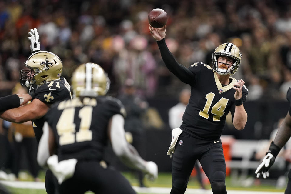 New Orleans Saints quarterback Andy Dalton (14) throws a pass to Alvin Kamara (41) during the second half of an NFL football game against the Cincinnati Bengals in New Orleans, Sunday, Oct. 16, 2022. (AP Photo/Gerald Herbert)