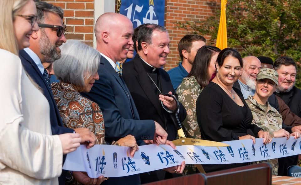 Dignitaries line up for photos and to cut a ribbon as Montgomery Catholic Preparatory School celebrates its 150th anniversary Tuesday in Montgomery.