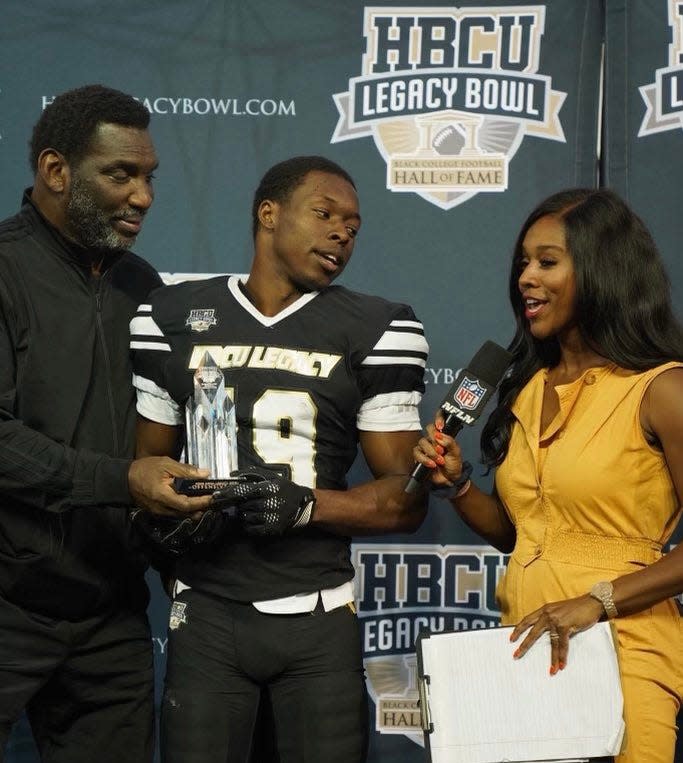 Florida A&M football wide receiver Xavier Smith (middle) receives HBCU Legacy Bowl Offensive MVP Award from Super Bowl winning quarterback Doug Williams (left) at Tulane's Yulman Stadium in New Orleans, Louisiana on Feb. 25, 2023