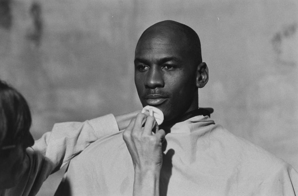 Michael Jordan, preparing to model a line of formal wear, sits while makeup artist Marty Thompson dusts his chin. (Photo: Steve Kagan/The LIFE Images Collection via Getty Images)