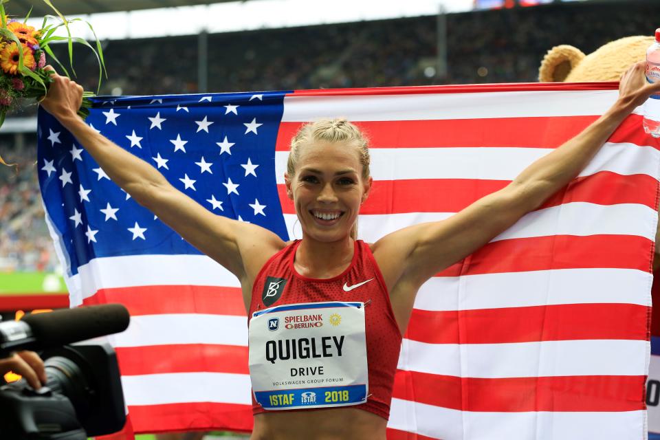 Steeplechaser Colleen Quigley poses with an American flag.