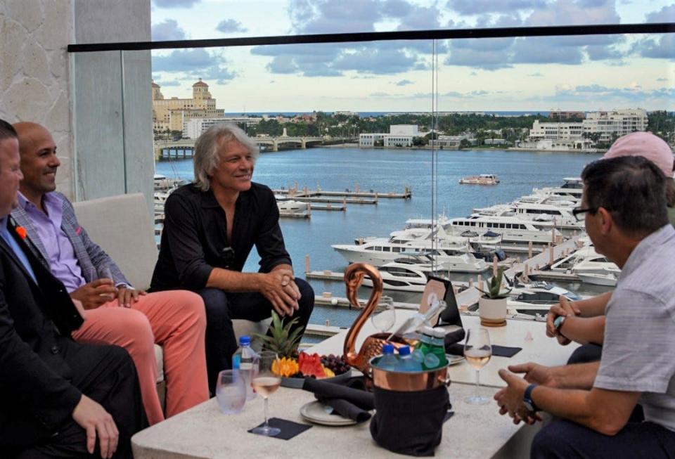 With a view of Palm Beach island in the backdrop, rocker Jon Bon Jovi chats about his wine, Hampton Water, at The Ben Hotel in West Palm Beach. The singer, who has a home on the island, visited the hotel with his son Jesse Bongiovi, who heads the wine brand.