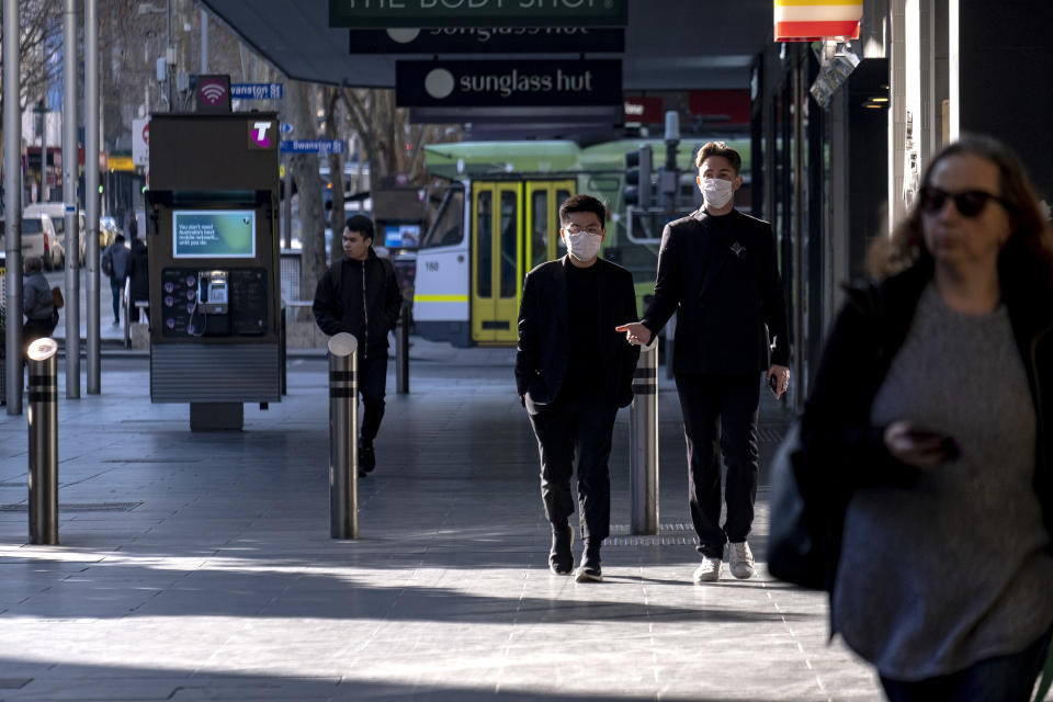 People wearing face masks are seen during a lockdown in Melbourne.