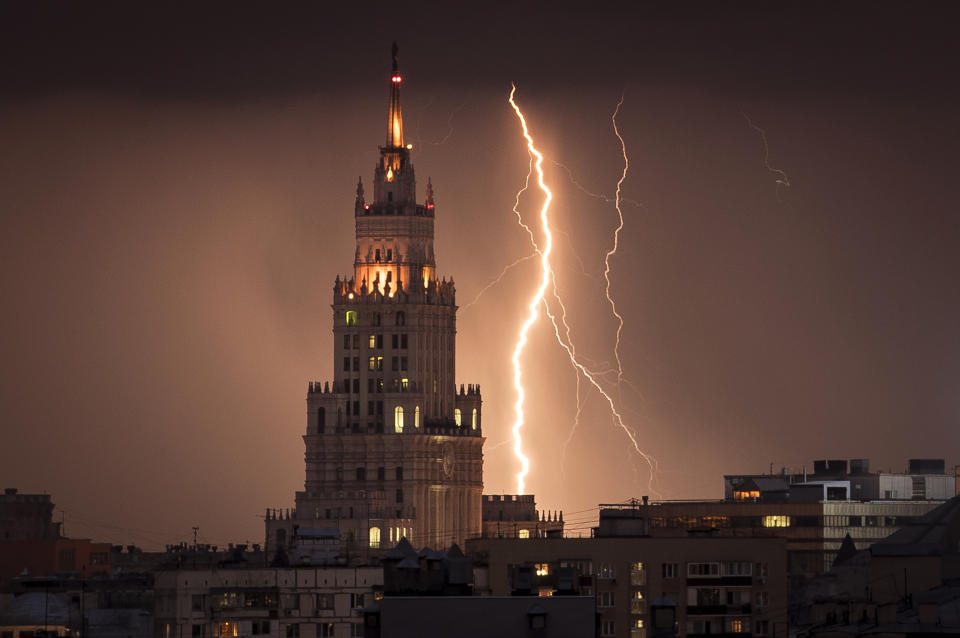 A lightning bolt striking a Stalin era skyscraper during a storm over Moscow