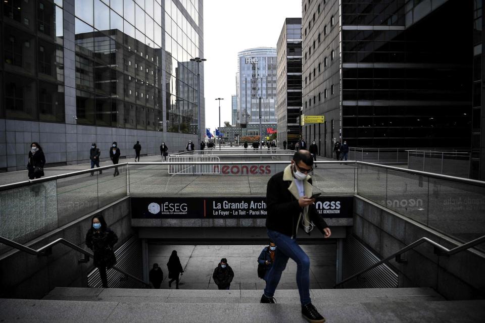 People wearing protective face masks in the business district of La Defense, west of Paris: AFP via Getty Images