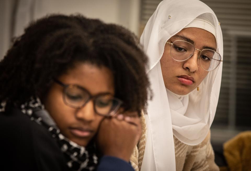 Cornell University student Laila Salih, 20, from Seattle, Wash., photographed on campus Nov. 6, 2023. She says that when she first arrived on campus, she did not wear her scarf so as not to be identified as Muslim. Recently she has taken to wearing it, and says that her parents call her every day because they fear for her safety. At left is graduate student and Palestinian supporter Juwuanna McAllister, 26.