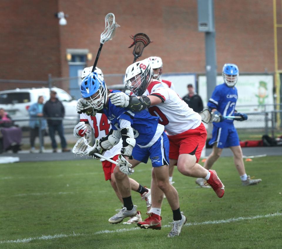 Spaulding's Jonas Levesque, right, defends a Hollis-Brookline player during last Wednesday's Division II boys lacrosse game.