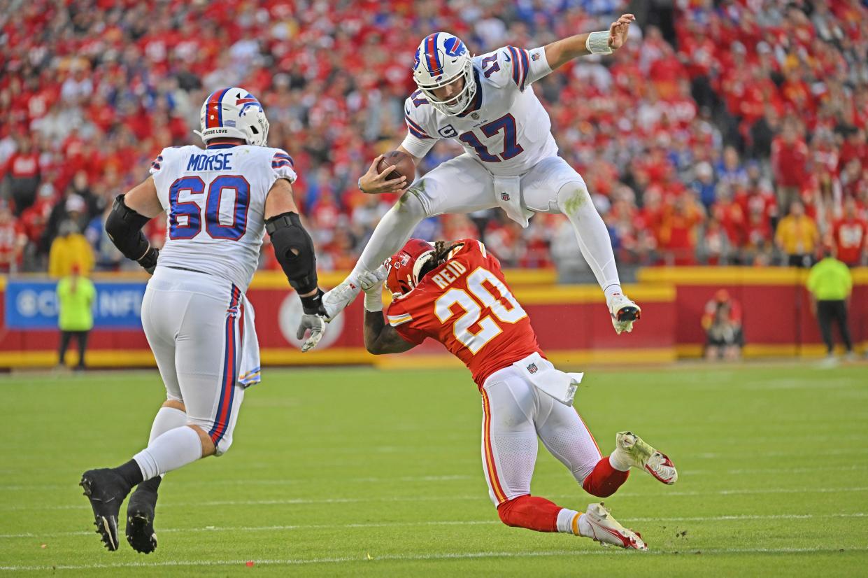 Buffalo Bills quarterback Josh Allen (17) hurdles Kansas City Chiefs safety Justin Reid (20) during an NFL football game Sunday, Oct. 16, 2022, in Kansas City, Mo. (AP Photo/Peter Aiken)