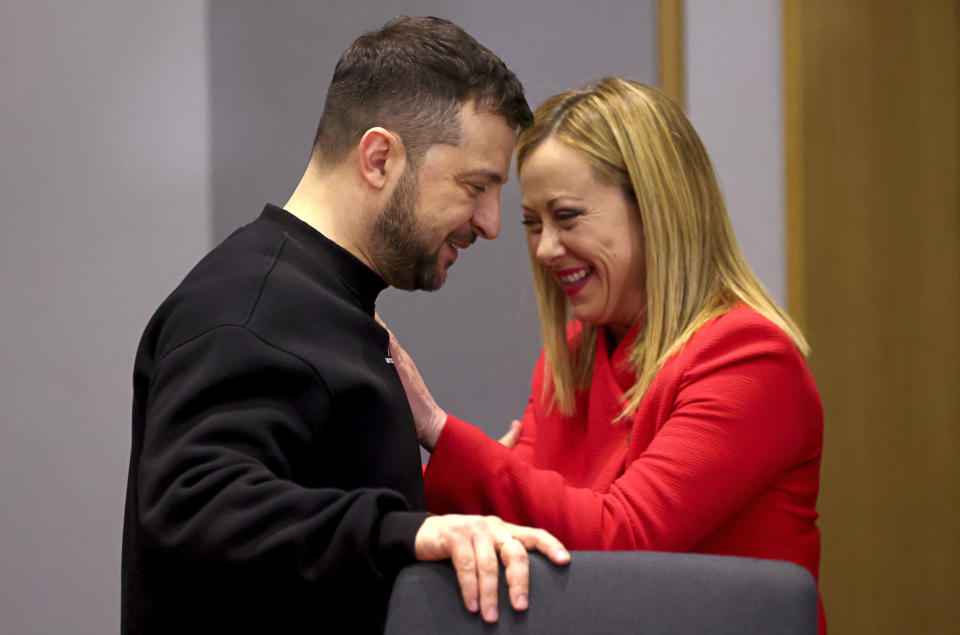 FILE - Ukraine's President Volodymyr Zelenskyy, left, speaks with Italy's Prime Minister Giorgia Meloni during a bilateral meeting at an EU summit in Brussels on Feb. 9, 2023. Former Premier Silvio Berlusconi has once again put himself at odds with Premier Giorgia Meloni, whose coalition government his party supports, by openly criticizing her for meeting with Ukraine’s leader, whom he blames for the year-old Russian invasion. (Johanna Geron, Pool Photo via AP, File)