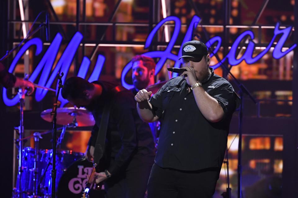 Luke Combs performs "Beer Never Broke My Heart" at the 53rd annual CMA Awards at Bridgestone Arena, Wednesday, Nov. 13, 2019, in Nashville, Tenn. (AP Photo/Mark J. Terrill)