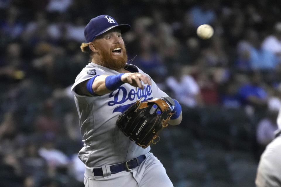 Los Angeles Dodgers third baseman Justin Turner makes a throw against the Arizona Diamondbacks in the fourth inning during a baseball game, Sunday, Aug 1, 2021, in Phoenix. (AP Photo/Rick Scuteri)