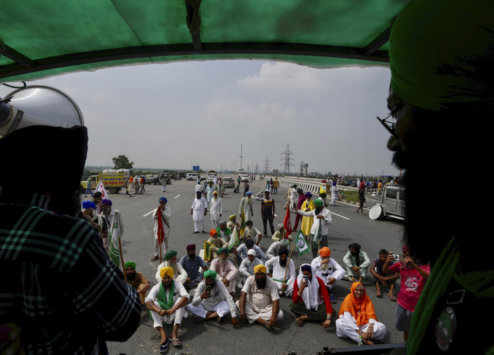 Protesting farmers gather at Singhu, outskirts of New Delhi, India, Monday, Sept.27, 2021. Thousands of Indian farmers Monday blocked traffic on major roads and railway tracks outside of the nation's capital, calling on the government to rescind agricultural laws that they say will shatter their livelihoods. The farmers called for a nation-wide strike to mark one year since the legislation was passed, marking a return to protests that began over a year ago. (AP Photo/Manish Swarup)