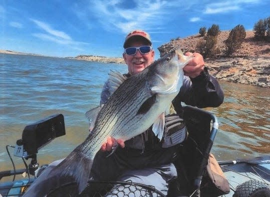 Gary Nussbaum II shows off his record-length wiper caught in the Pueblo Reservoir in 2023.