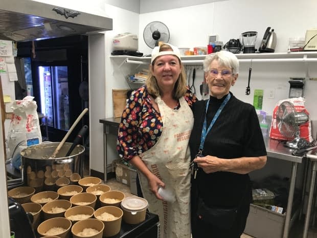 Volunteers Danica Fletcher and Sepkhae Lind work to provide meals distributed to Kamloops residents in need through the Kamloops COVID Meal Train.  (Doug Herbert/CBC - image credit)