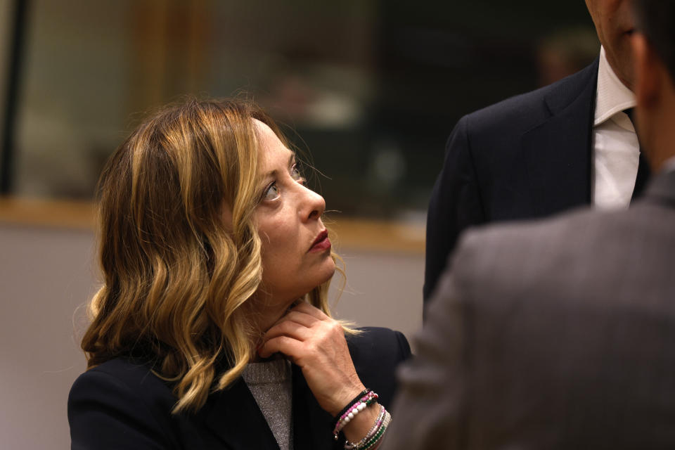 Italy's Prime Minister Giorgia Meloni, left, looks up at Netherland's Prime Minister Mark Rutte and French President Emmanuel Macron during a round table meeting at an EU summit in Brussels, Wednesday, April 17, 2024. European leaders' discussions at a summit in Brussels were set to focus on the bloc's competitiveness in the face of increased competition from the United States and China. Tensions in the Middle East and the ongoing war between Russia and Ukraine decided otherwise and the 27 leaders will dedicate Wednesday evening talks to foreign affairs. (AP Photo/Omar Havana)